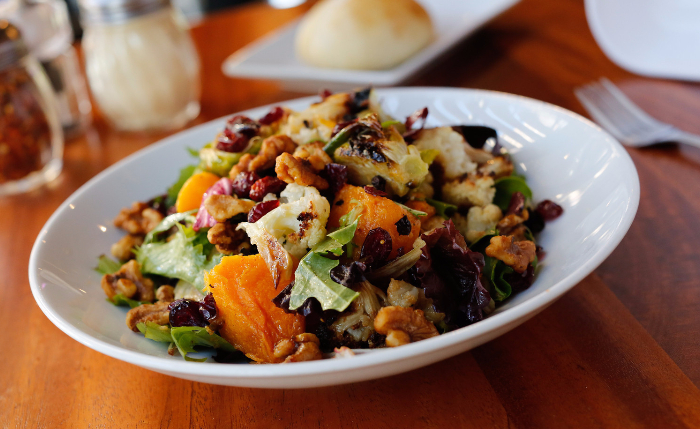 Roasted Vegetable Salad set at a table with condiments