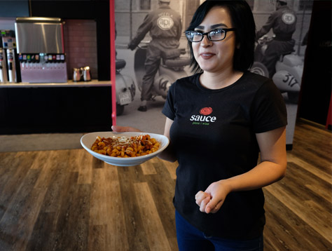 Sauce Team Member serving pasta