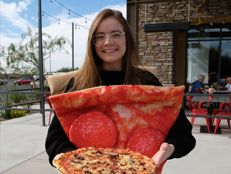 Sauce Pizza & Wine fan wearing a pizza slice costume