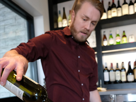 Sauce Team Member pouring wine