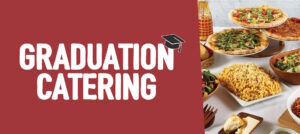 A display of an assortment of foods for graduation catering from Sauce Pizza and Wine, including pizza, salads, pasta, and macaroni and cheese.